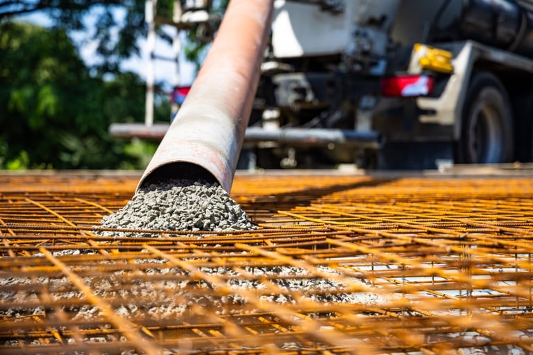 Professional concrete pouring at construction site